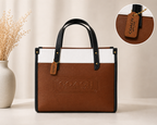 Cognac Brown & Cognac Coach Tabby Shoulder Bag 26 features a distinct brass "C" logo hardware
