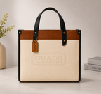 Beige Coach Tabby Shoulder Bag 26 features a distinct brass "C" logo hardware