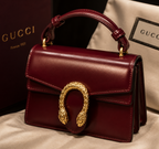 Maroon Gucci Dionysus top handle bag with a silver-tone tiger head closure.