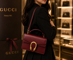 Maroon Gucci Dionysus top handle bag with a silver-tone tiger head closure.