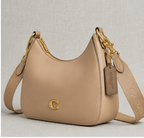 Coach Small Jonie 22 half-moon leather shoulder bag in a neutral color.