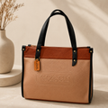 Sandstone Beige & Cognac Coach Tabby Shoulder Bag 26 features a distinct brass "C" logo hardware