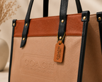 Sandstone Beige & Cognac Coach Tabby Shoulder Bag 26 features a distinct brass "C" logo hardware