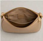 Coach Small Jonie 22 half-moon leather shoulder bag in a neutral color.
